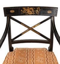 A Set of Twelve Regency Ebonized and Parcel Gilt Dining Chairs