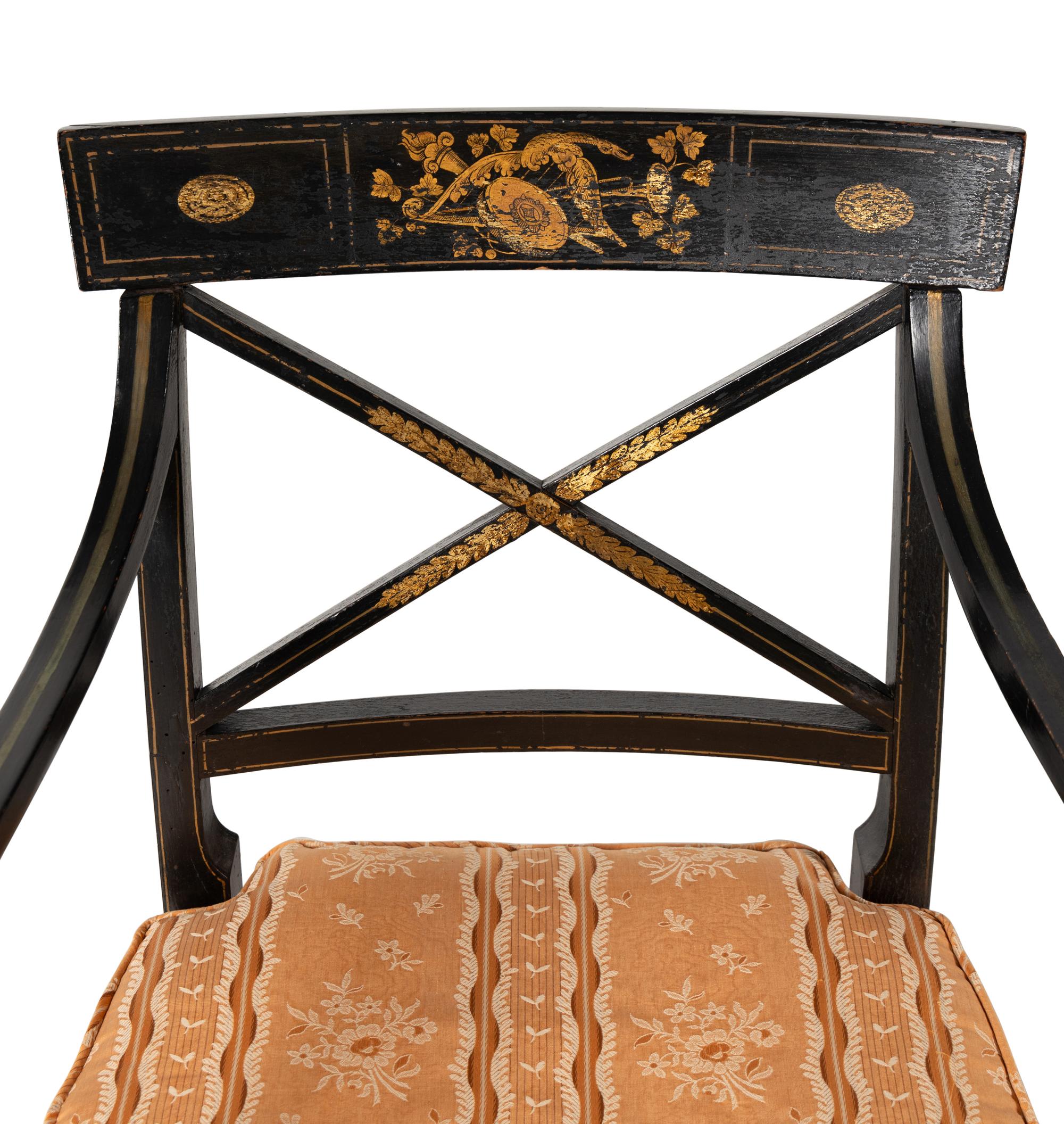 A Set of Twelve Regency Ebonized and Parcel Gilt Dining Chairs