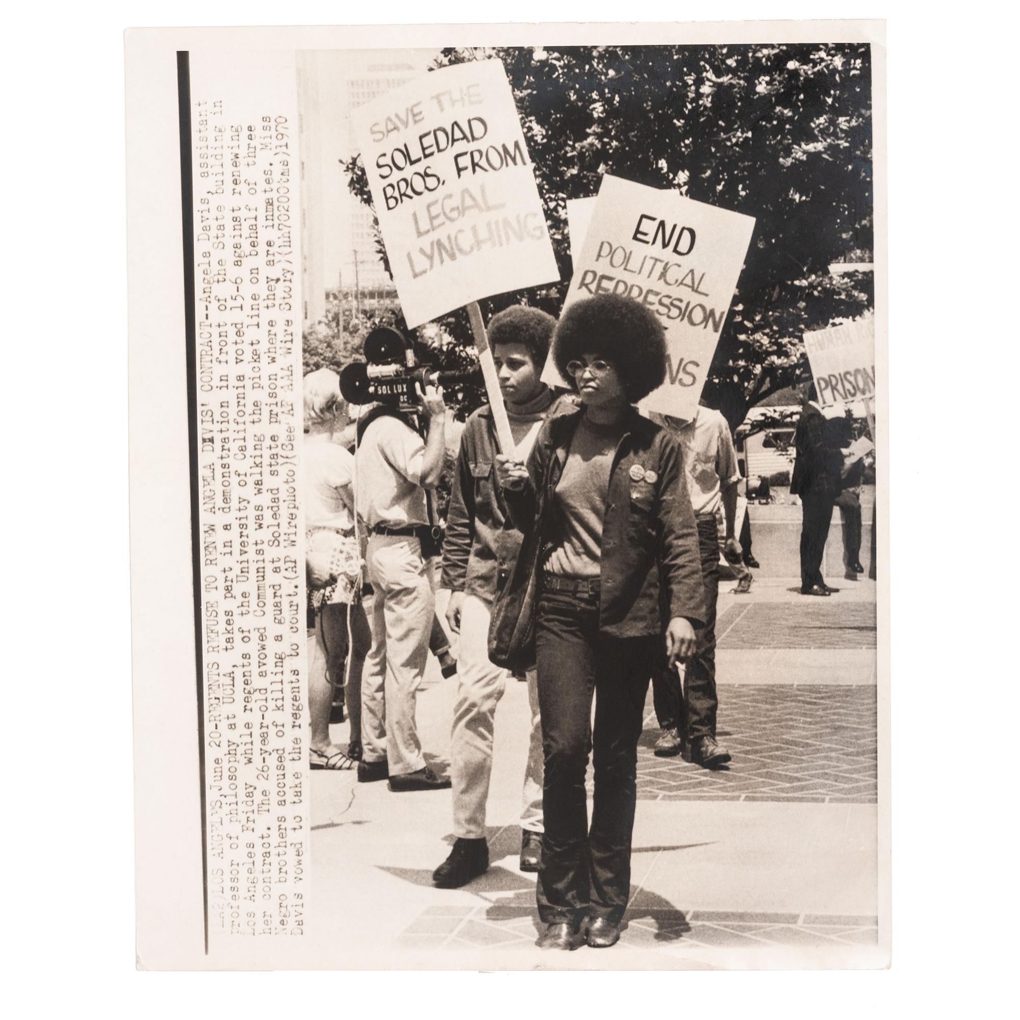 [DAVIS, Angela (b. 1944)]. Press photograph of Davis leading march for the Soledad Brothers in front of the State building in Los Angeles, while regents at UCLA voted against renewing her contract. Los Angeles, CA, 20 June 1970.