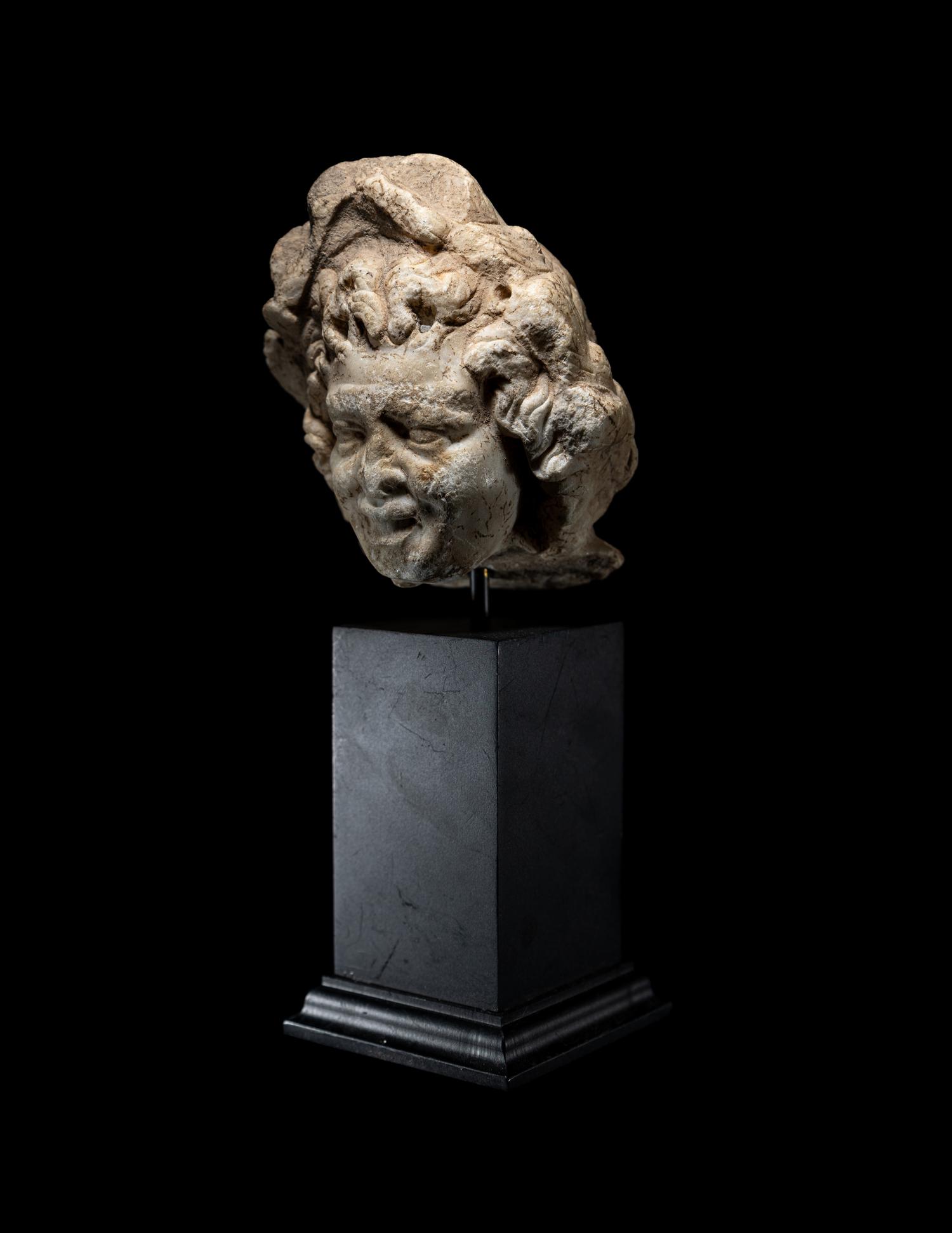 A Roman Marble Head of a Satyr