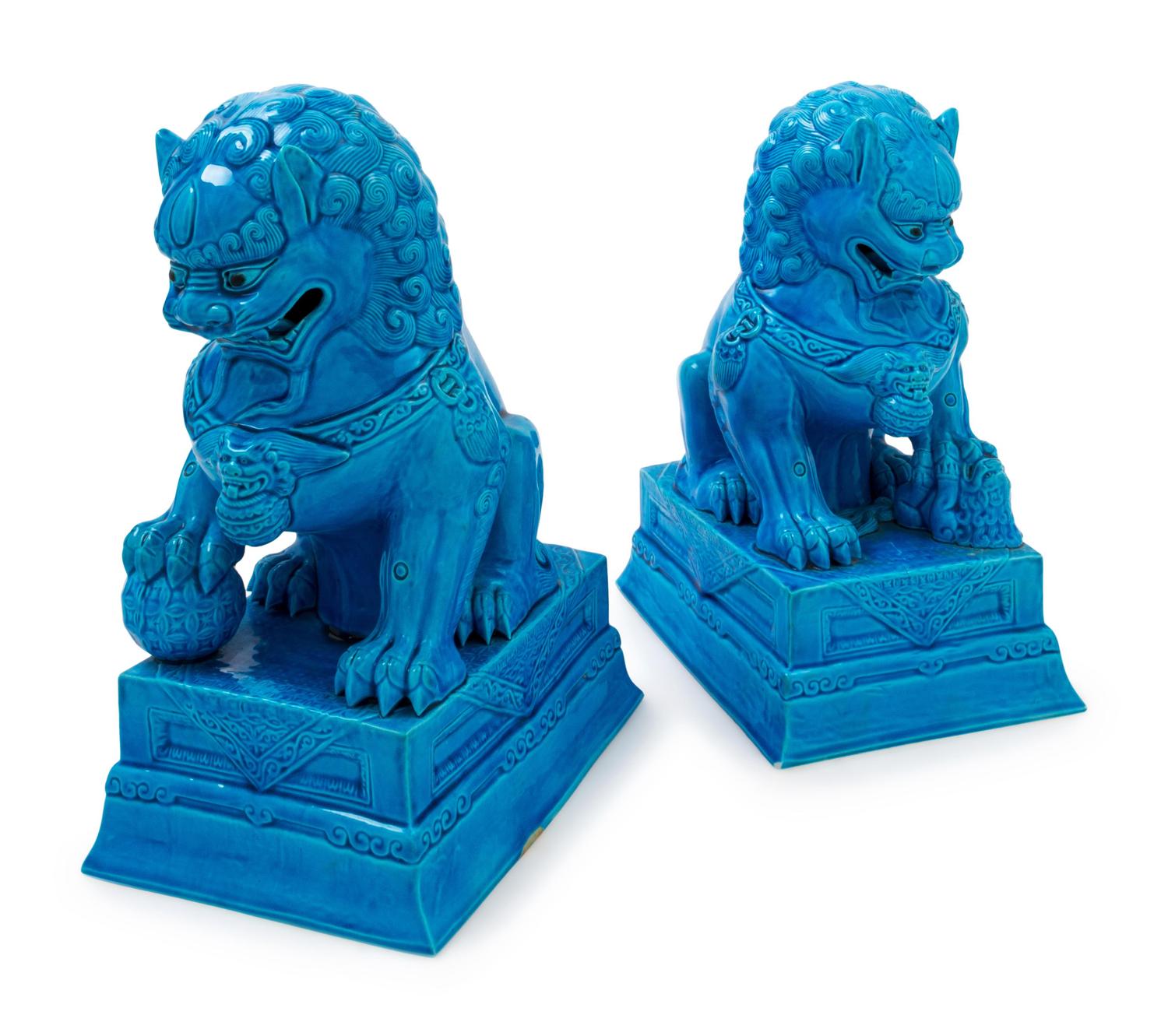 A Pair of Chinese Turquoise Glazed Porcelain Figures of Fu Lions