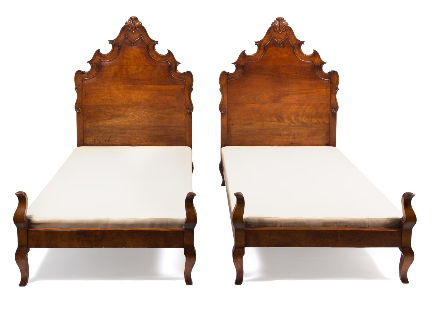A Pair of Venetian Style Walnut Twin Beds Height 58 x width 39 x depth 73 inches.