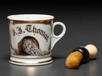 A Porcelain Occupational Shaving Mug Depicting a Bushel of Oysters