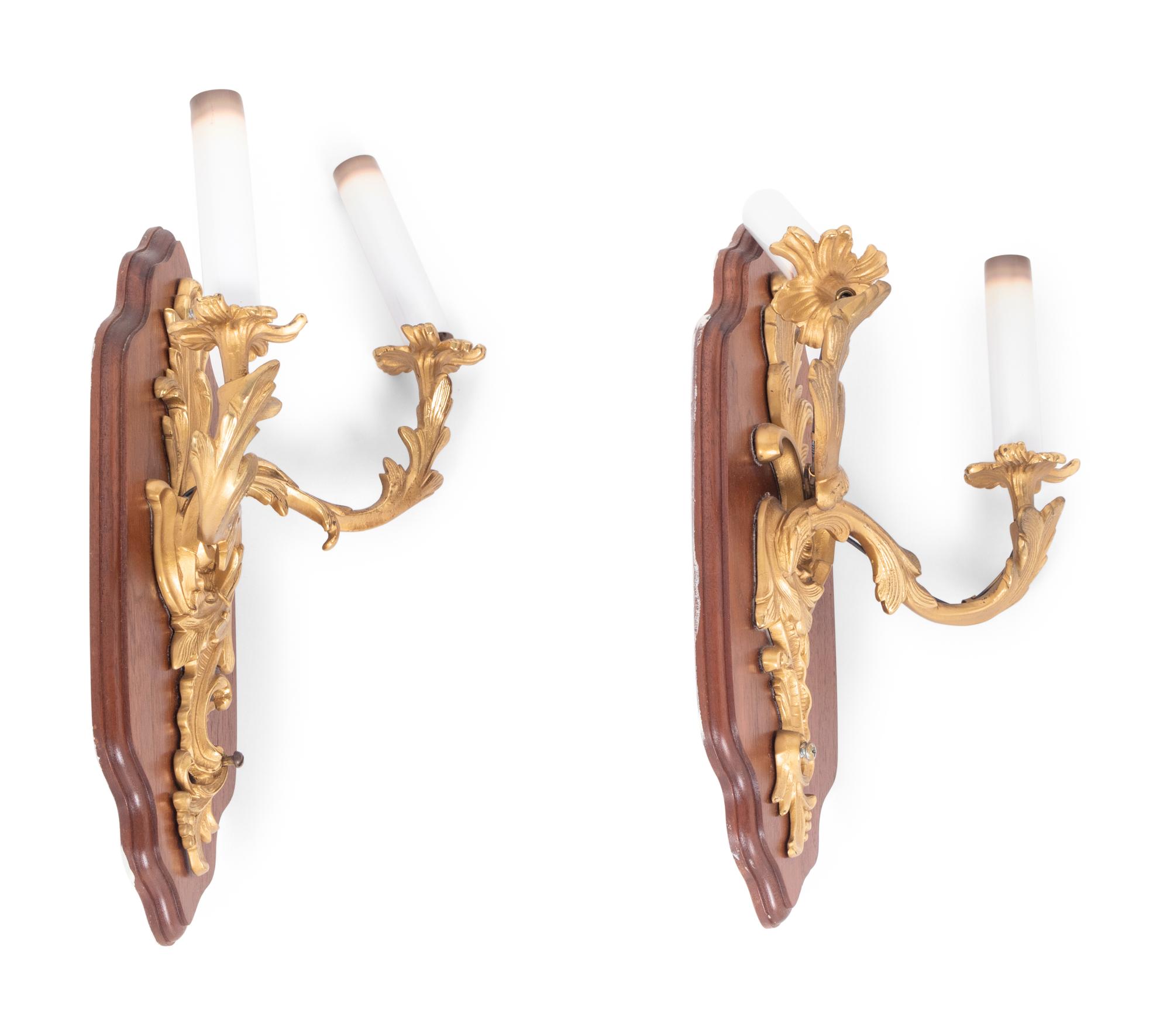 A Pair of Louis XV Style Gilt Metal Two-Light Sconces on Walnut Plaques
