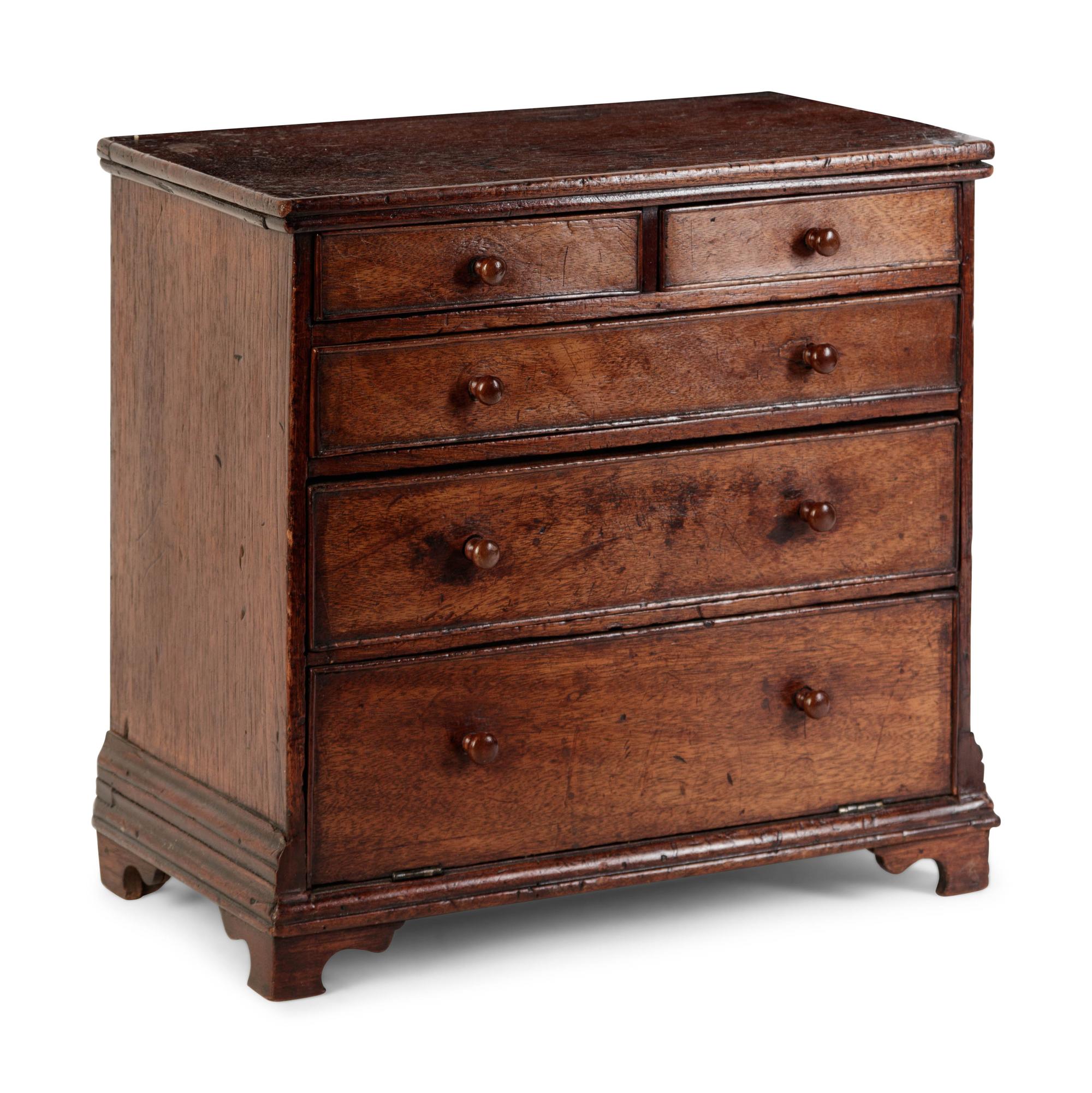 A Diminutive Walnut Chest of Drawers