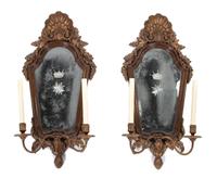 A Pair of Italian Rococo Style Parcel-Gilt Walnut Sconces