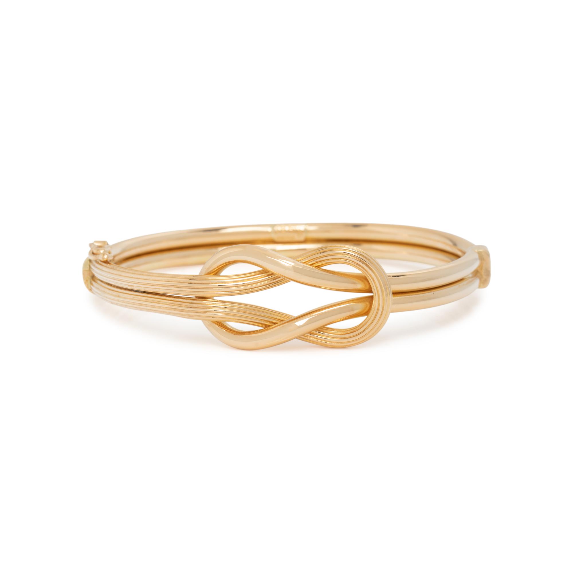 ILIAS LALAOUNIS, YELLOW GOLD BANGLE BRACELET