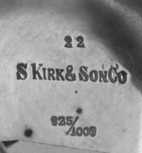 An American Silver Center Bowl, S. Kirk & Son, Baltimore, MD, worked to show floral and foliate repousse decoration, centered with an e