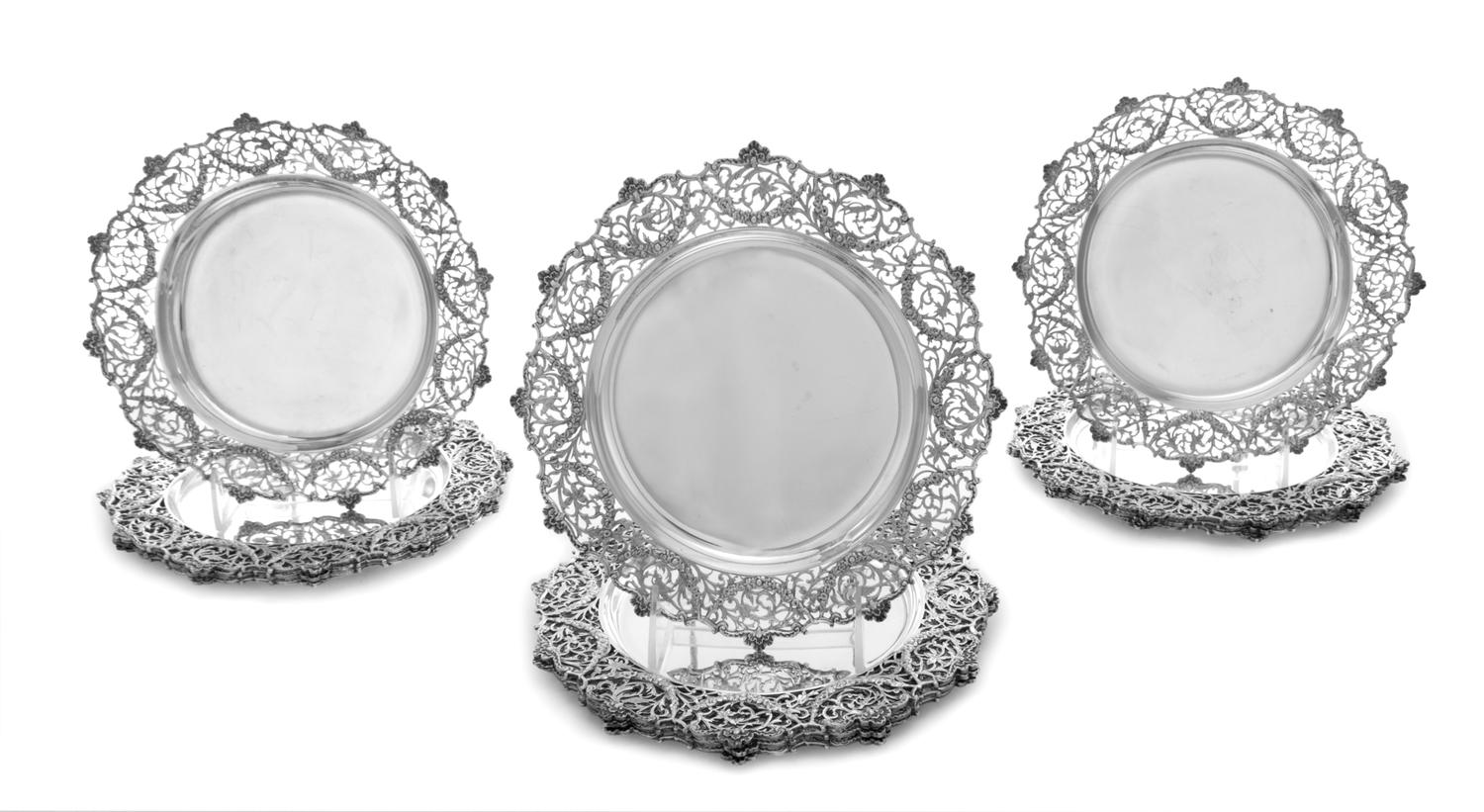 A Set of Twelve English Silver Plates , Elkington & Co., London, 1910 , each having pierced foliate scroll borders.