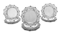 A Set of Twelve English Silver Plates , Elkington & Co., London, 1910 , each having pierced foliate scroll borders.