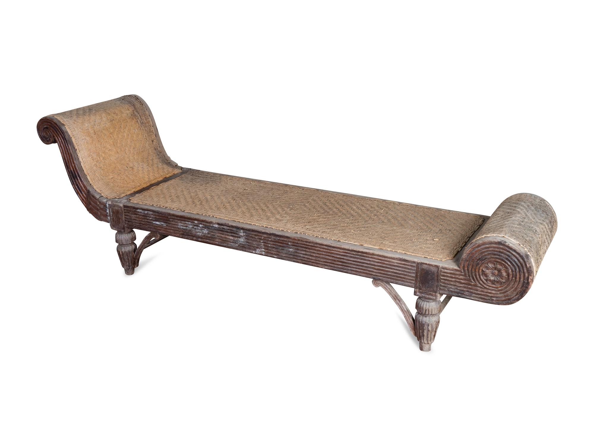 An Indonesian Carved Teak Chaise Longue — 20TH CENTURY