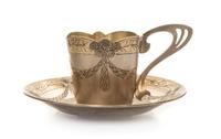 A Russian Art Nouveau Silver Cup and Saucer, Mark of Fifth Artel, Moscow, early 20th century, the cup having an undulating rim and hand