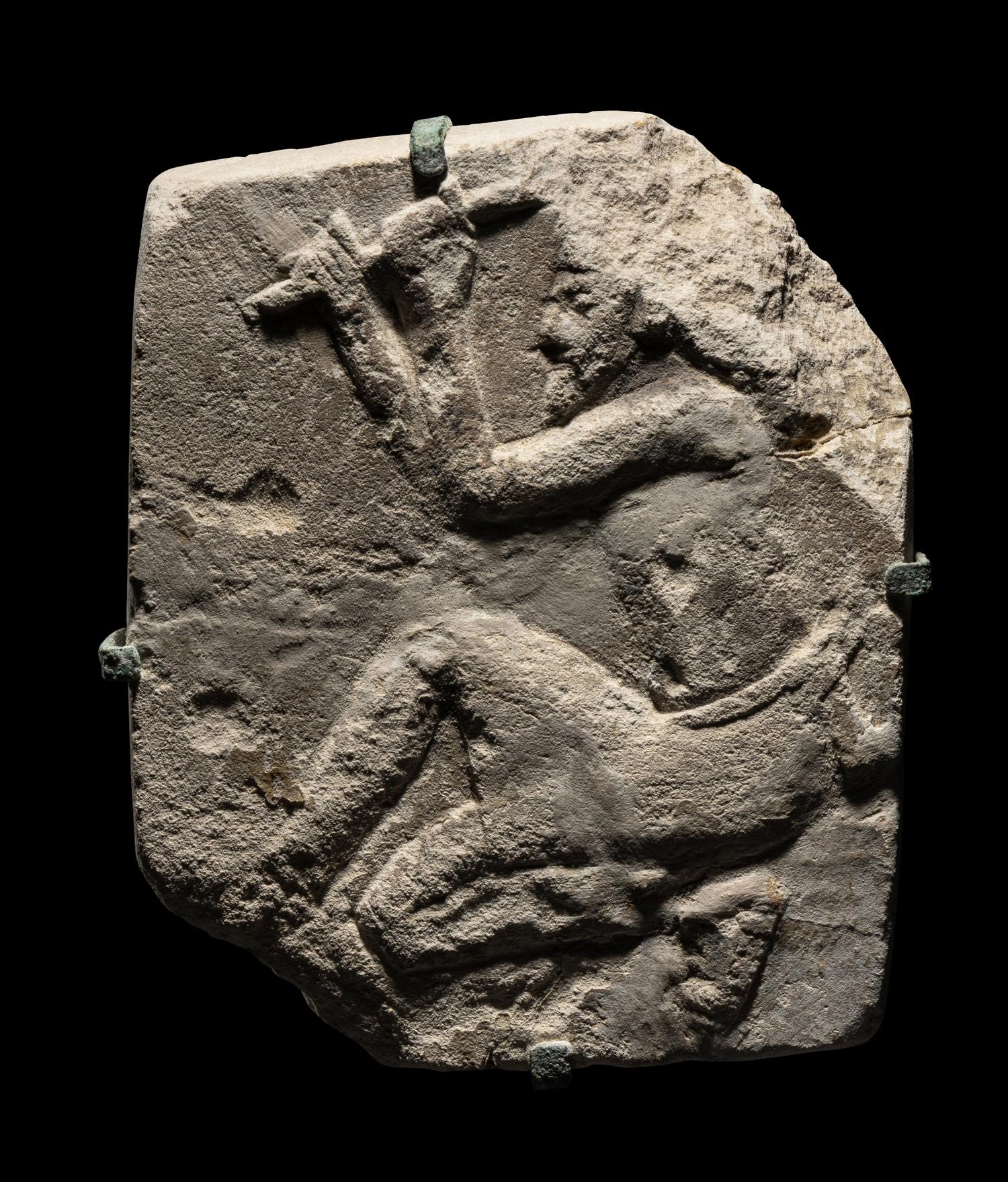 An Egyptian Limestone Relief of a Sculptor