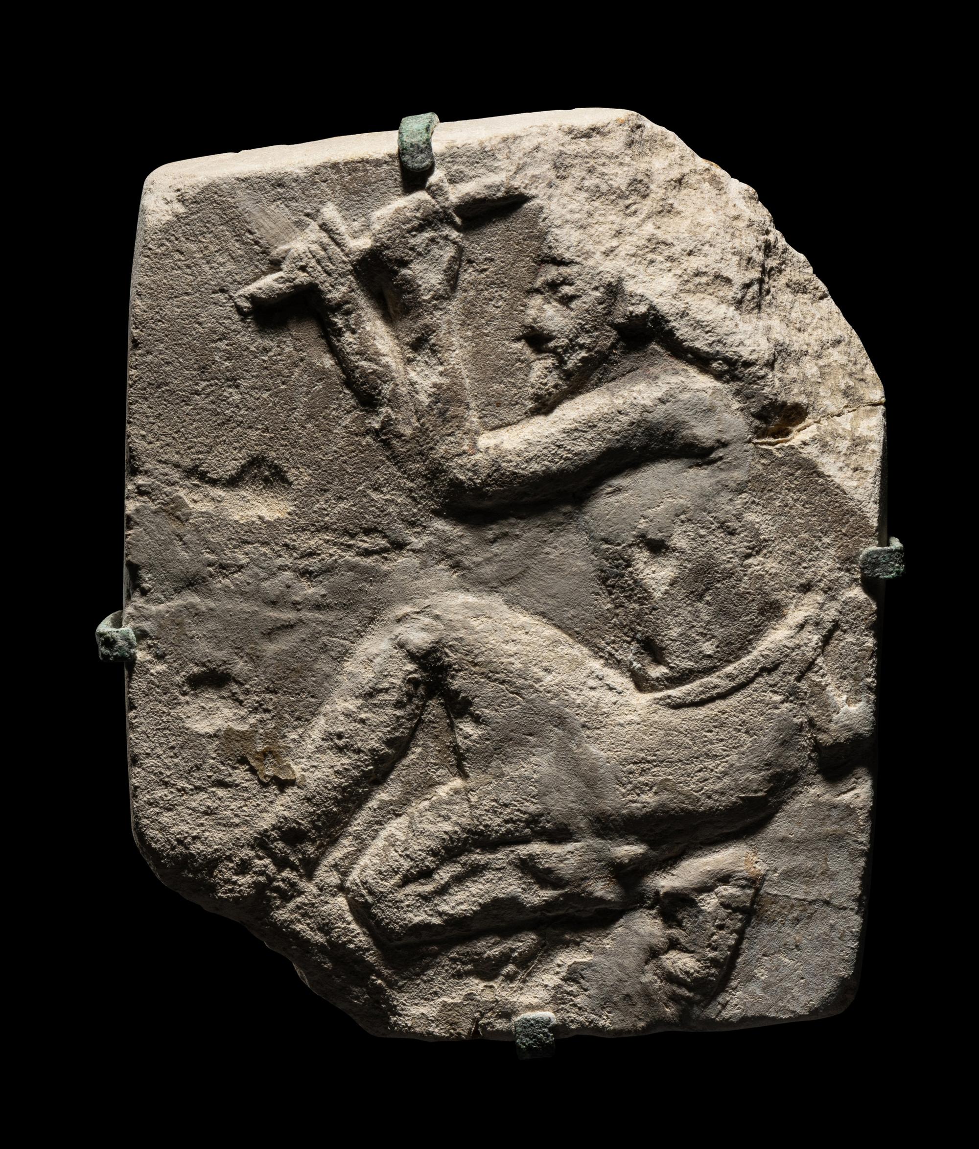 An Egyptian Limestone Relief of a Sculptor