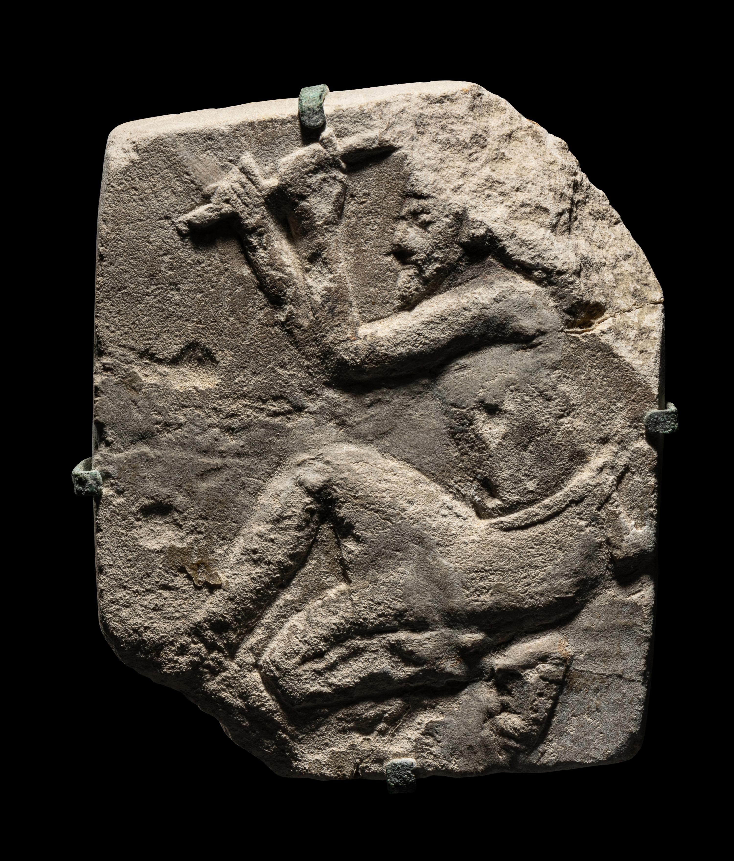 An Egyptian Limestone Relief of a Sculptor