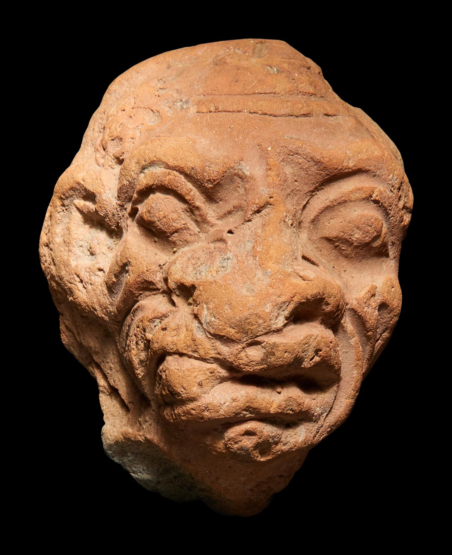 A Roman Terracotta Grotesque Head