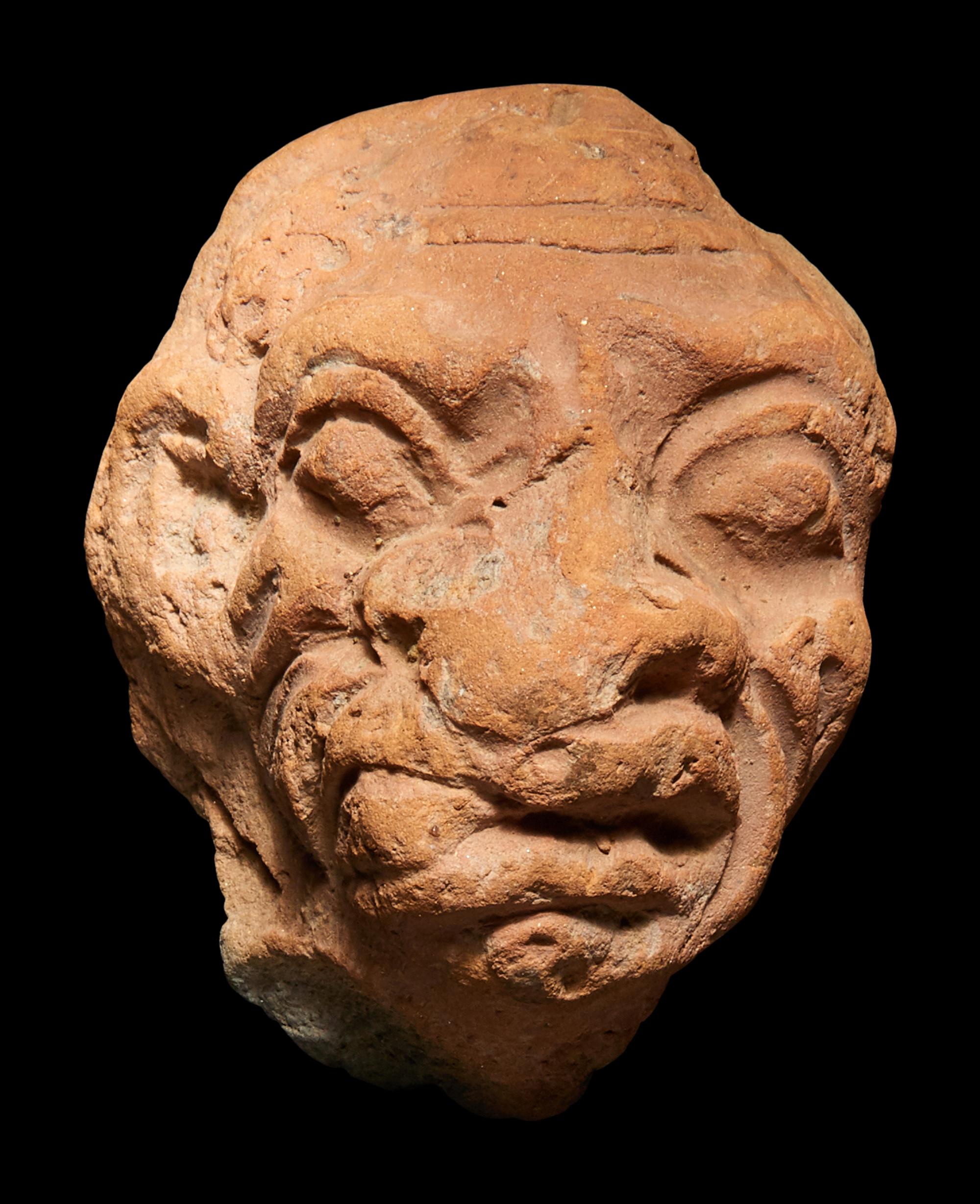 A Roman Terracotta Grotesque Head