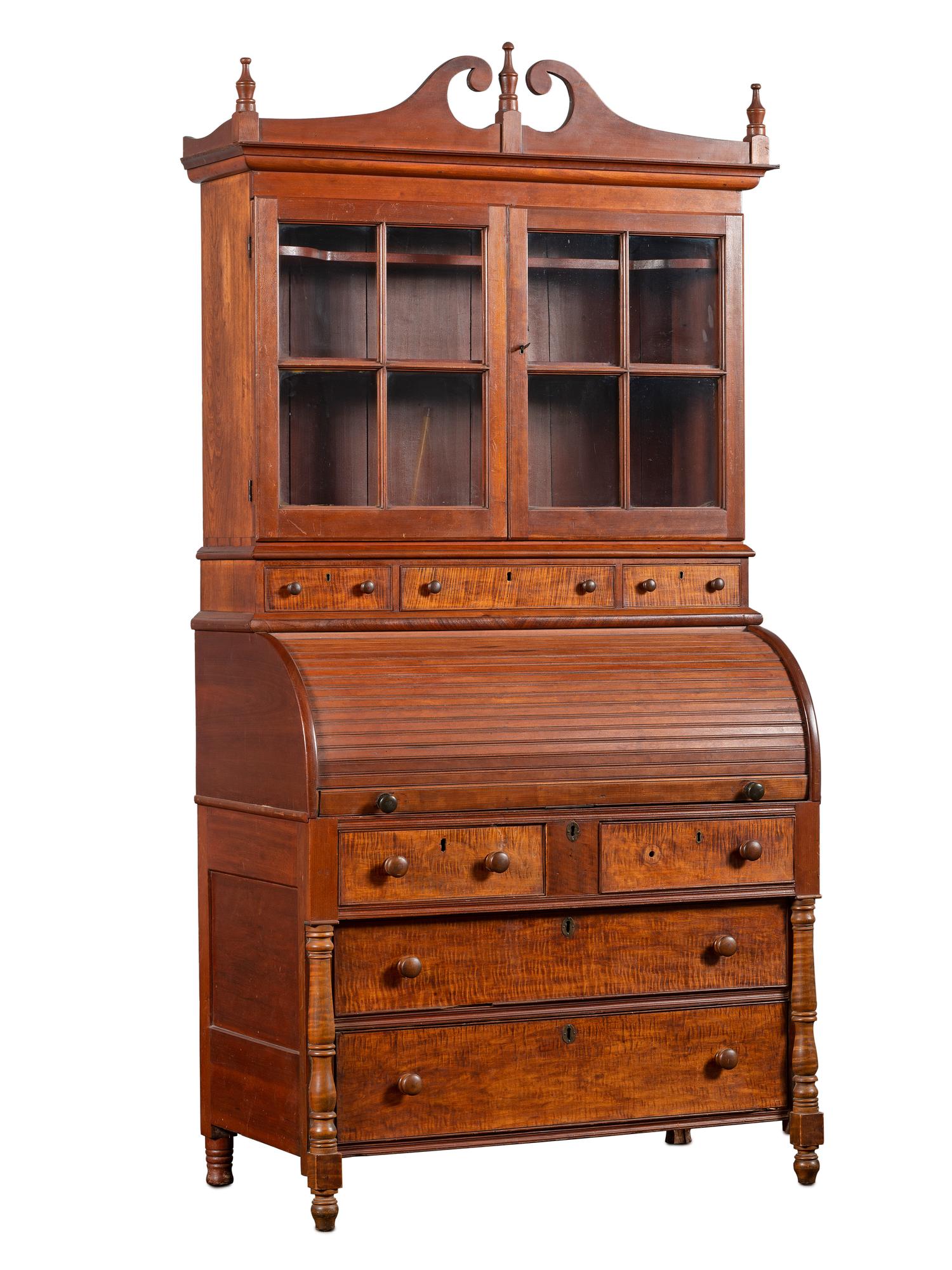 A Late Federal Cherry Wood and Tiger Maple Roll-Top Desk-and-Bookcase