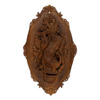 A Pair of Swiss "Black Forest" Carved Lindenwood Game Plaques