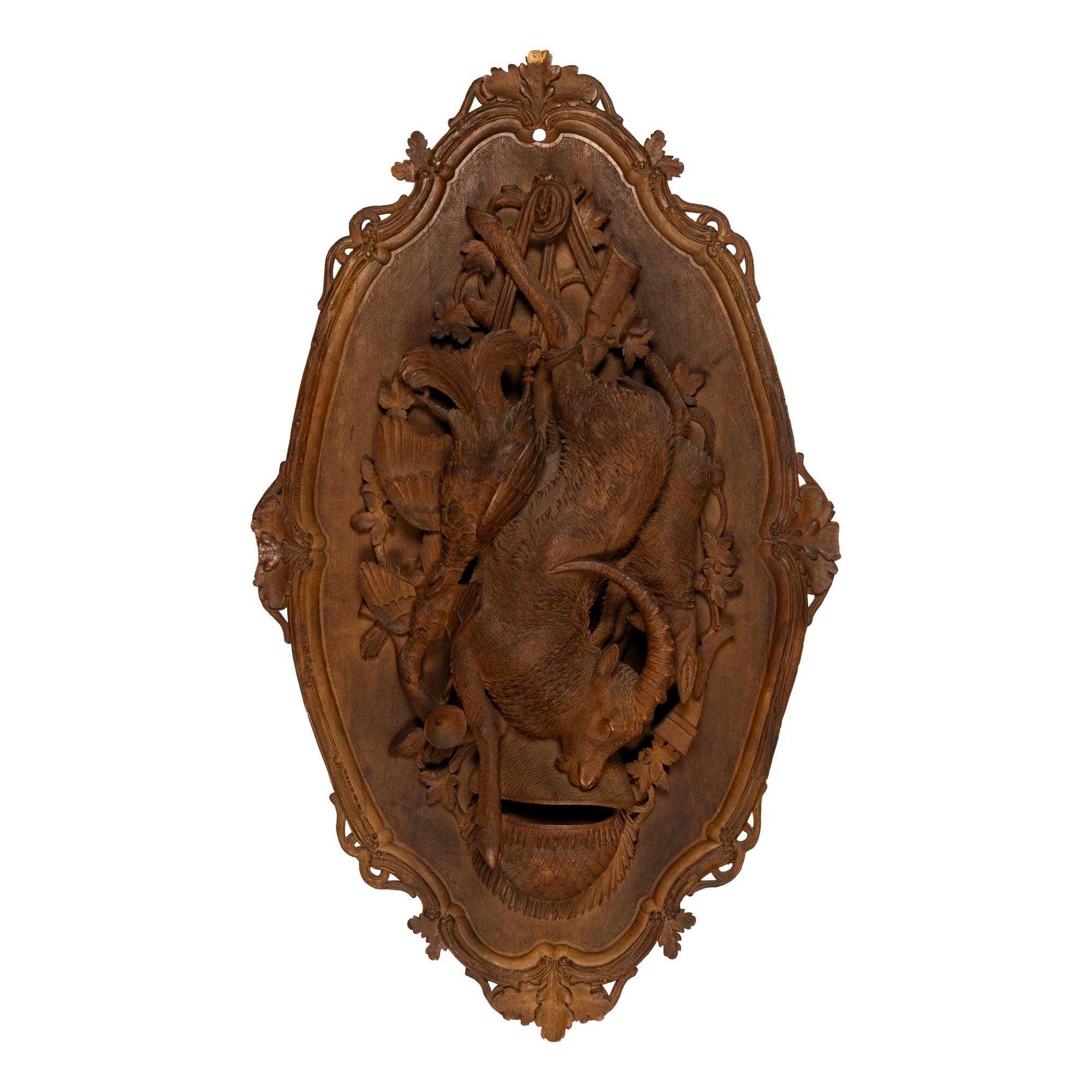 A Pair of Swiss "Black Forest" Carved Lindenwood Game Plaques