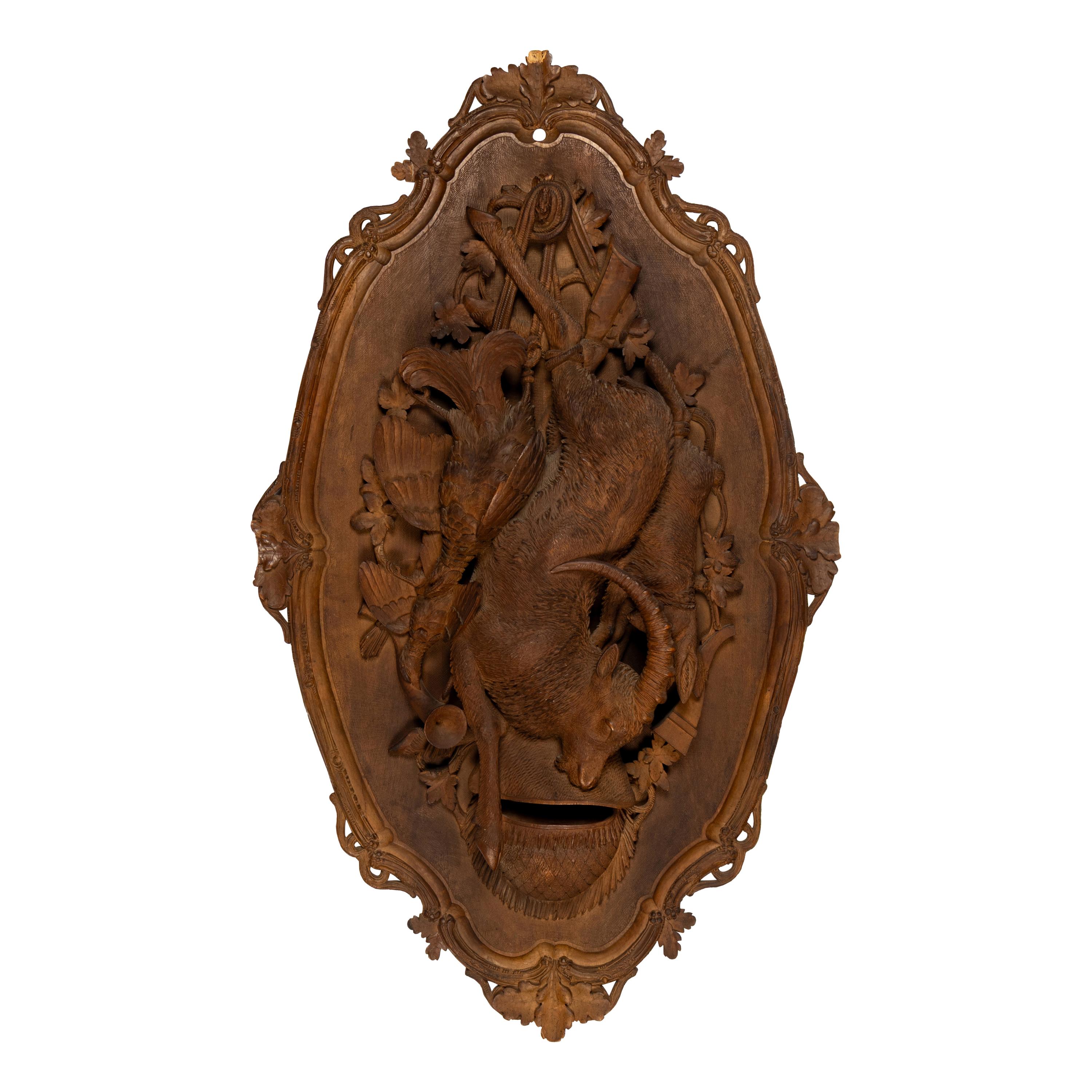 A Pair of Swiss "Black Forest" Carved Lindenwood Game Plaques