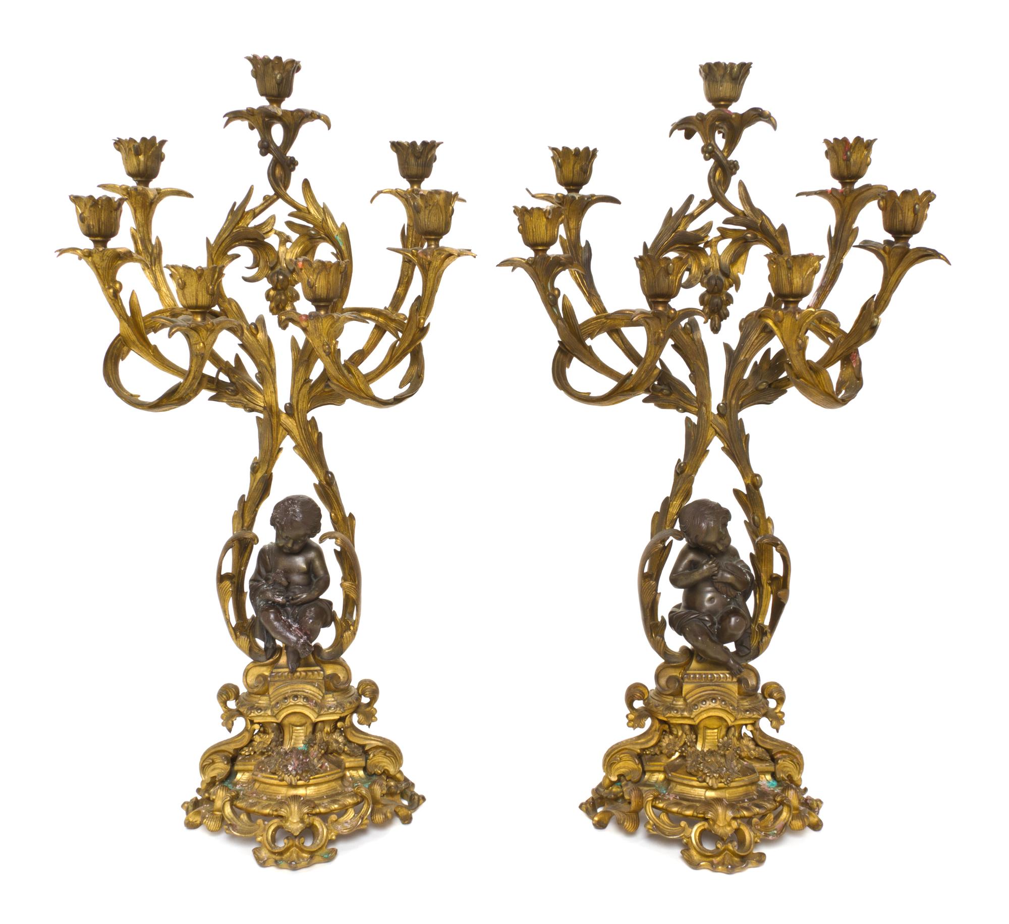 A Pair of Louis XV Style Gilt and Patinated Bronze Seven-Light Candelabra, Height 25 1/2 inches.