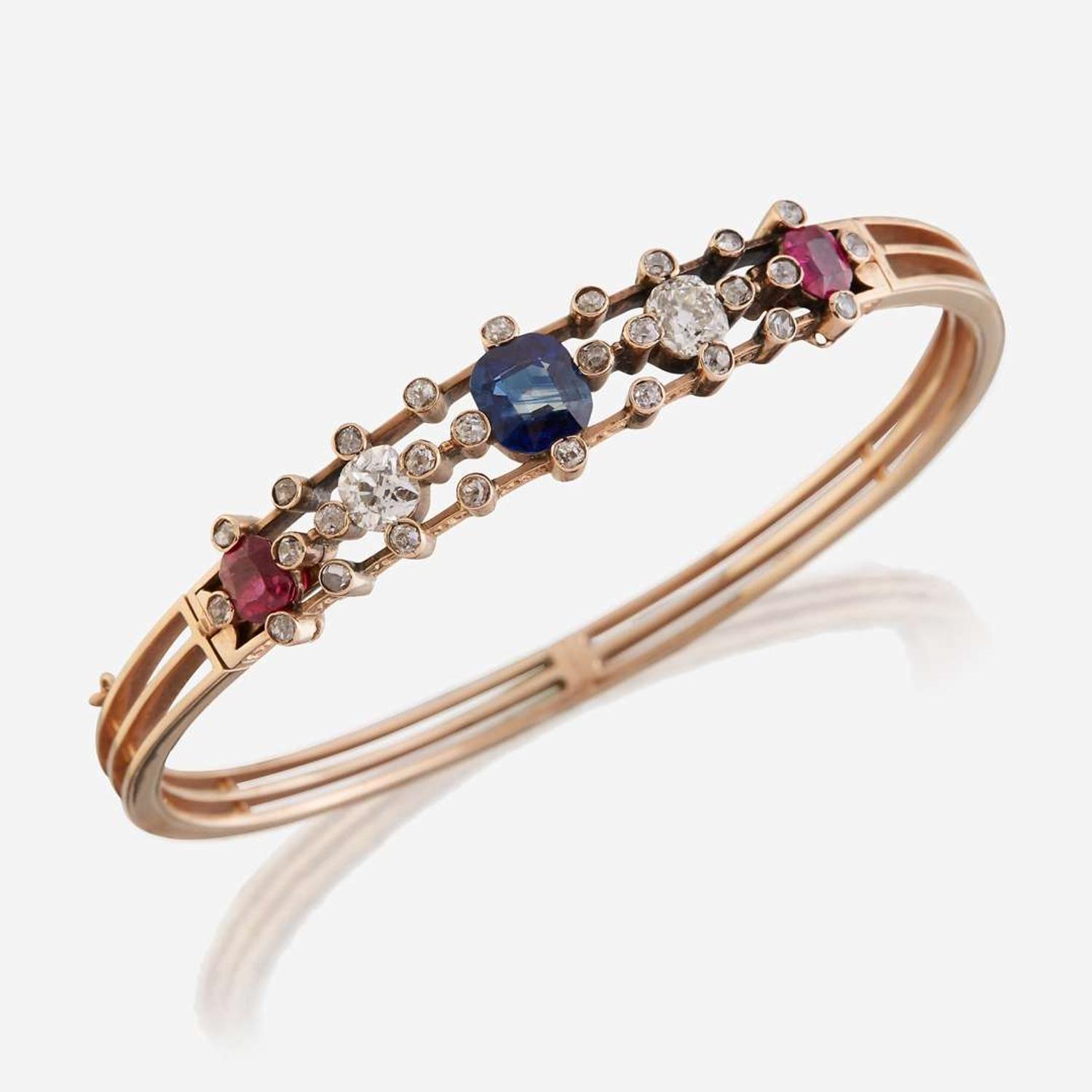 An antique fourteen karat rose gold, diamond, sapphire, and ruby bangle