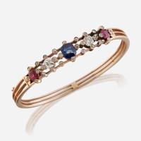 An antique fourteen karat rose gold, diamond, sapphire, and ruby bangle