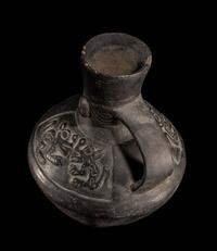 A Chimu Blackware Vessel with Human Face and Animal Motif