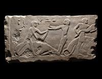 An Egyptian Limestone Relief Depicting Butchers