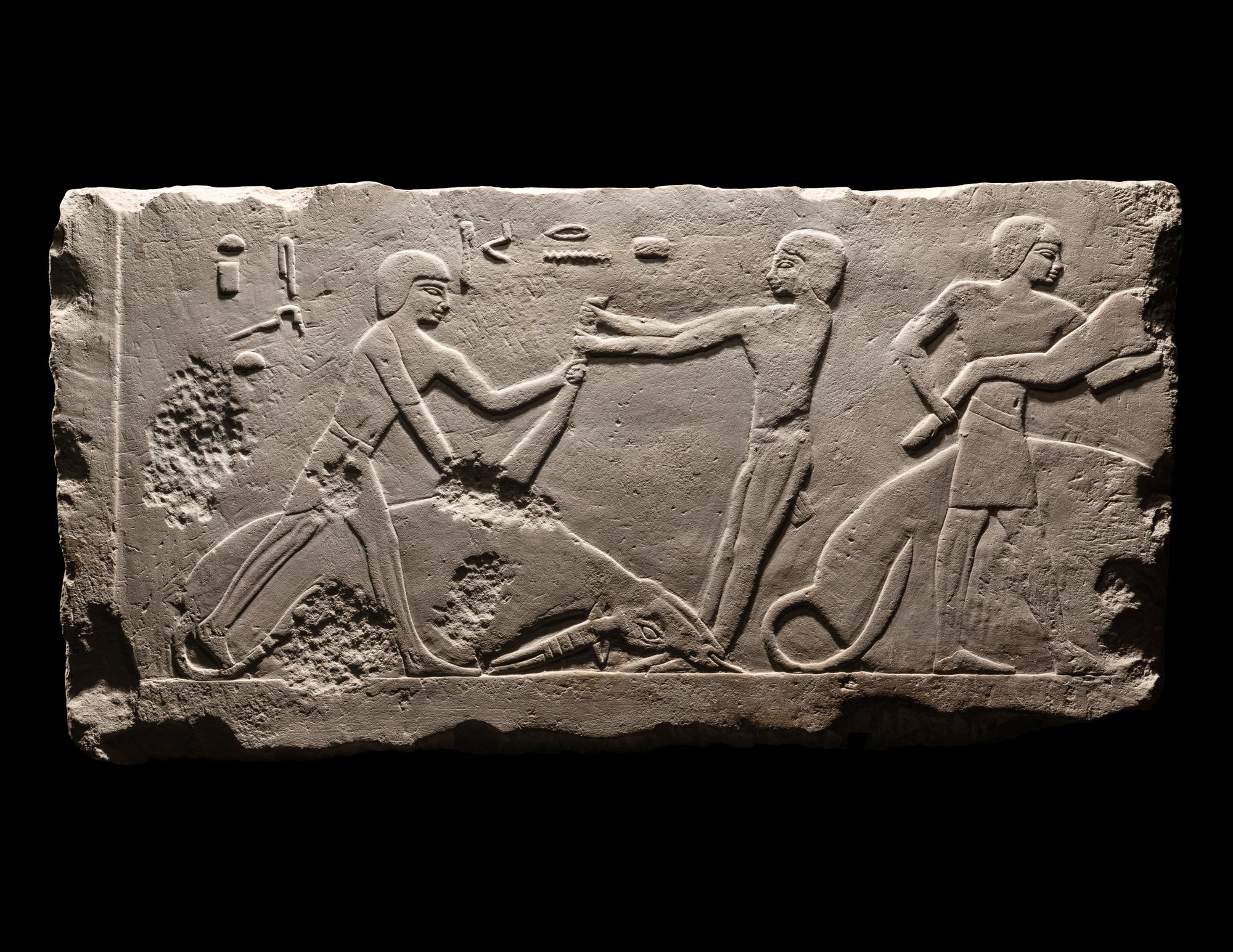 An Egyptian Limestone Relief Depicting Butchers