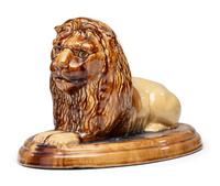 A Yellowware Recumbent Lion Figure