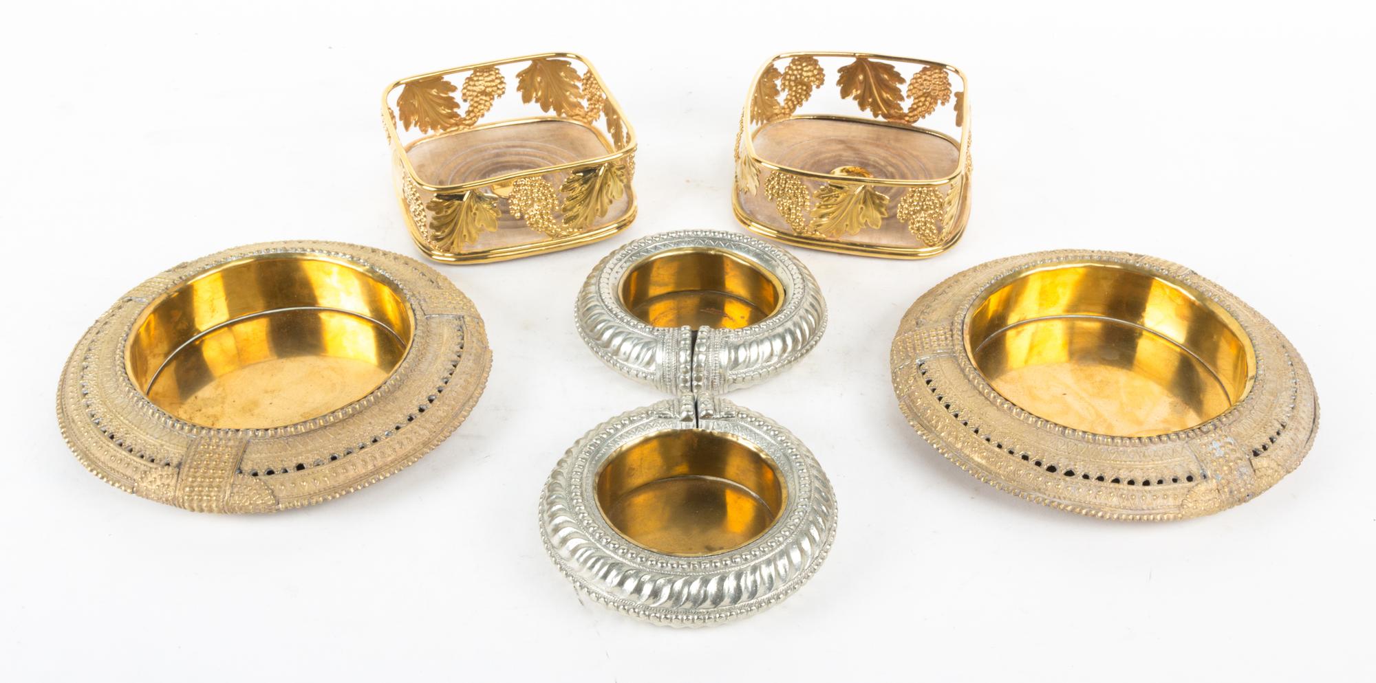 A Group of Brass Bottle Coasters Diameter of largest 9 inches.