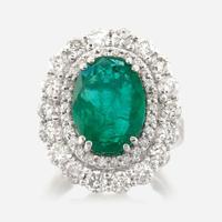 An emerald, diamond, and white gold ring
