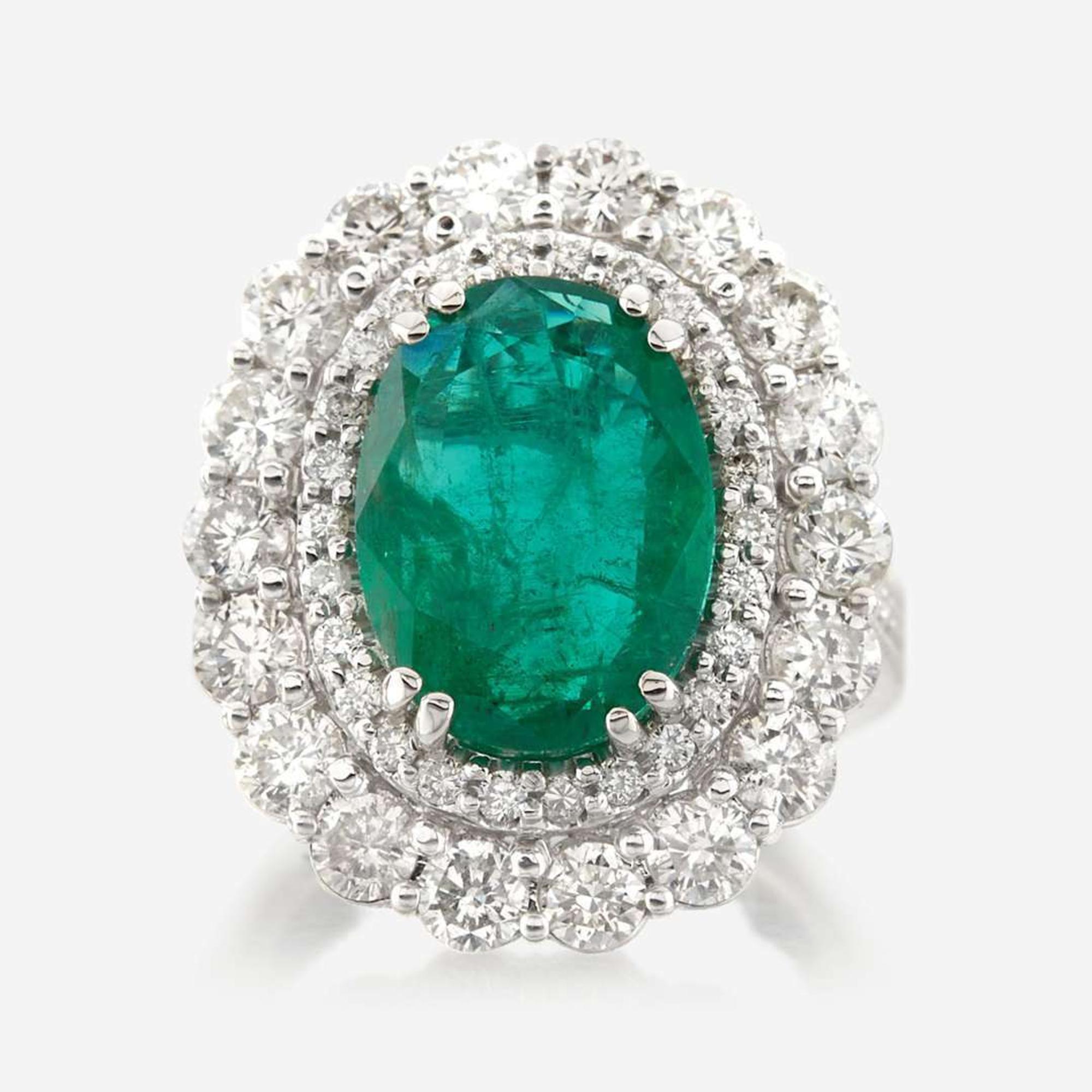 An emerald, diamond, and white gold ring
