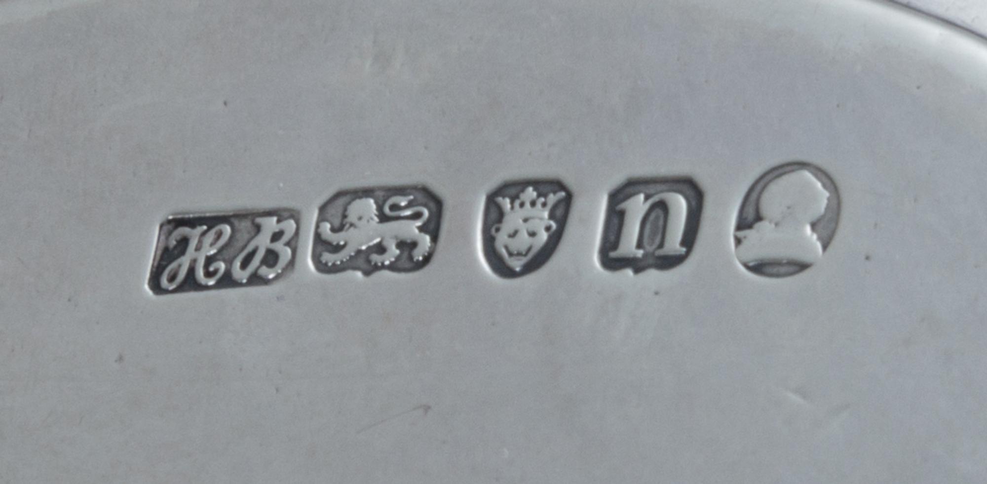 A George III Silver Stand, Hester Bateman, London, 1788, of oval form, having a central oval cartouche with an armorial depicting a lio