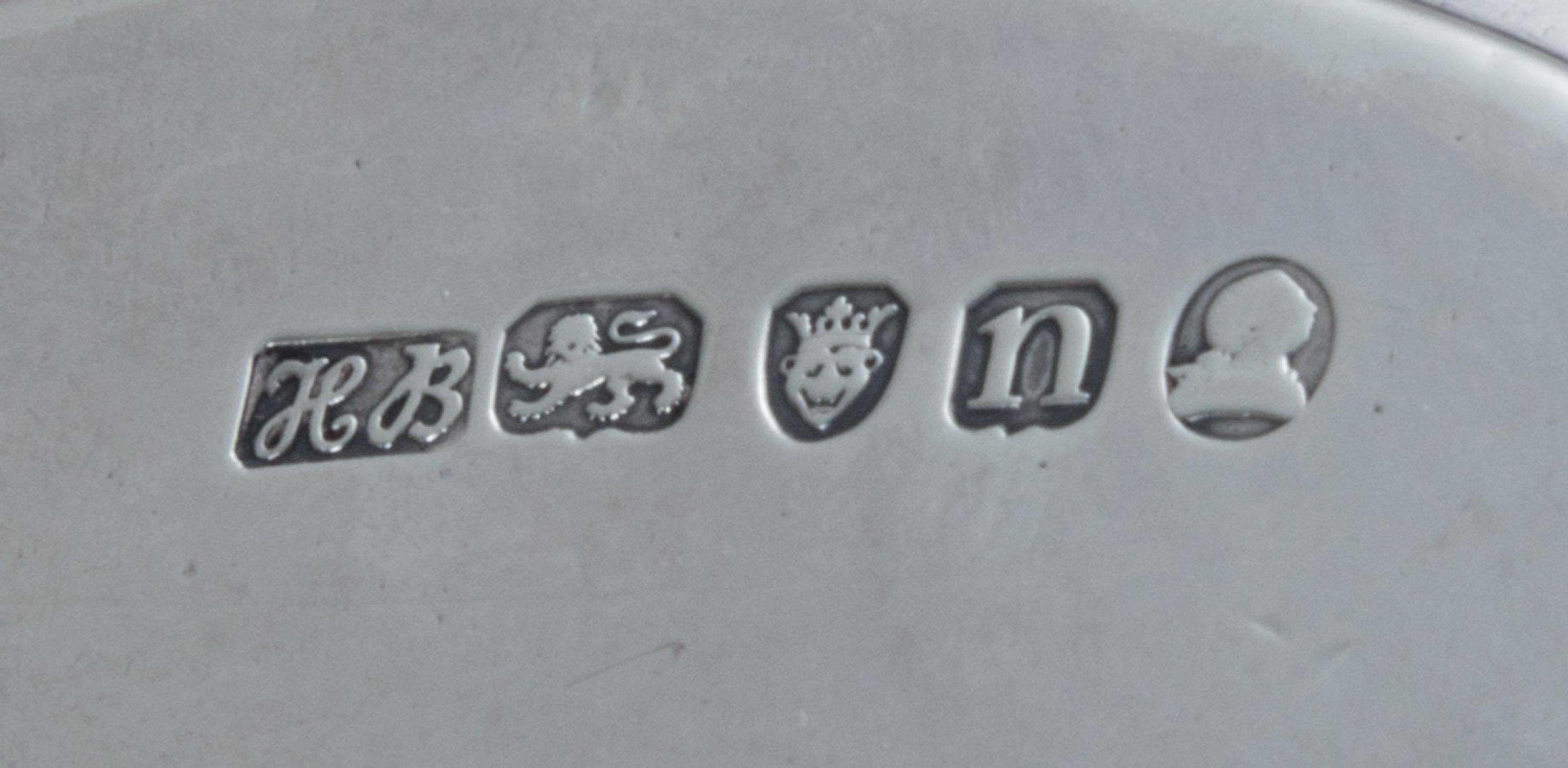 A George III Silver Stand, Hester Bateman, London, 1788, of oval form, having a central oval cartouche with an armorial depicting a lio