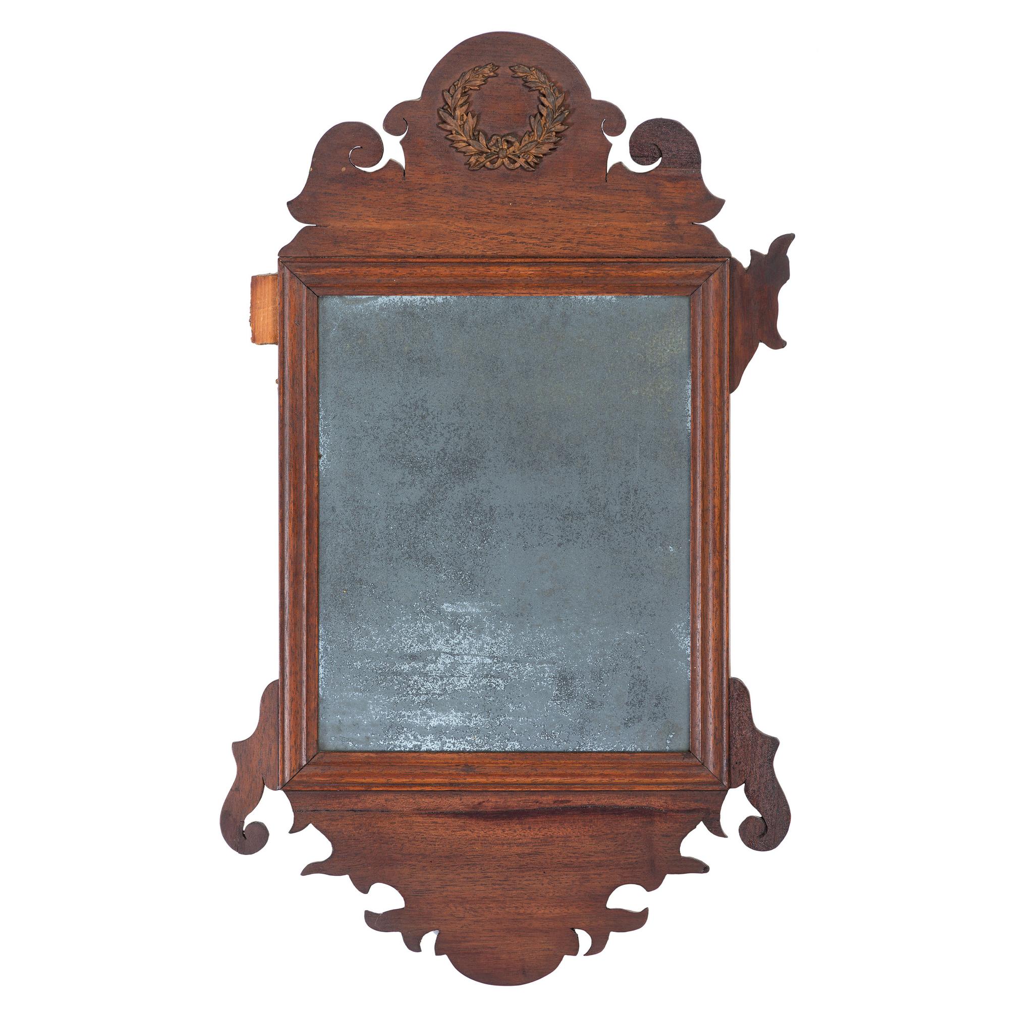 A Chippendale Style Parcel Gilt and Carved Mahogany Looking Glass