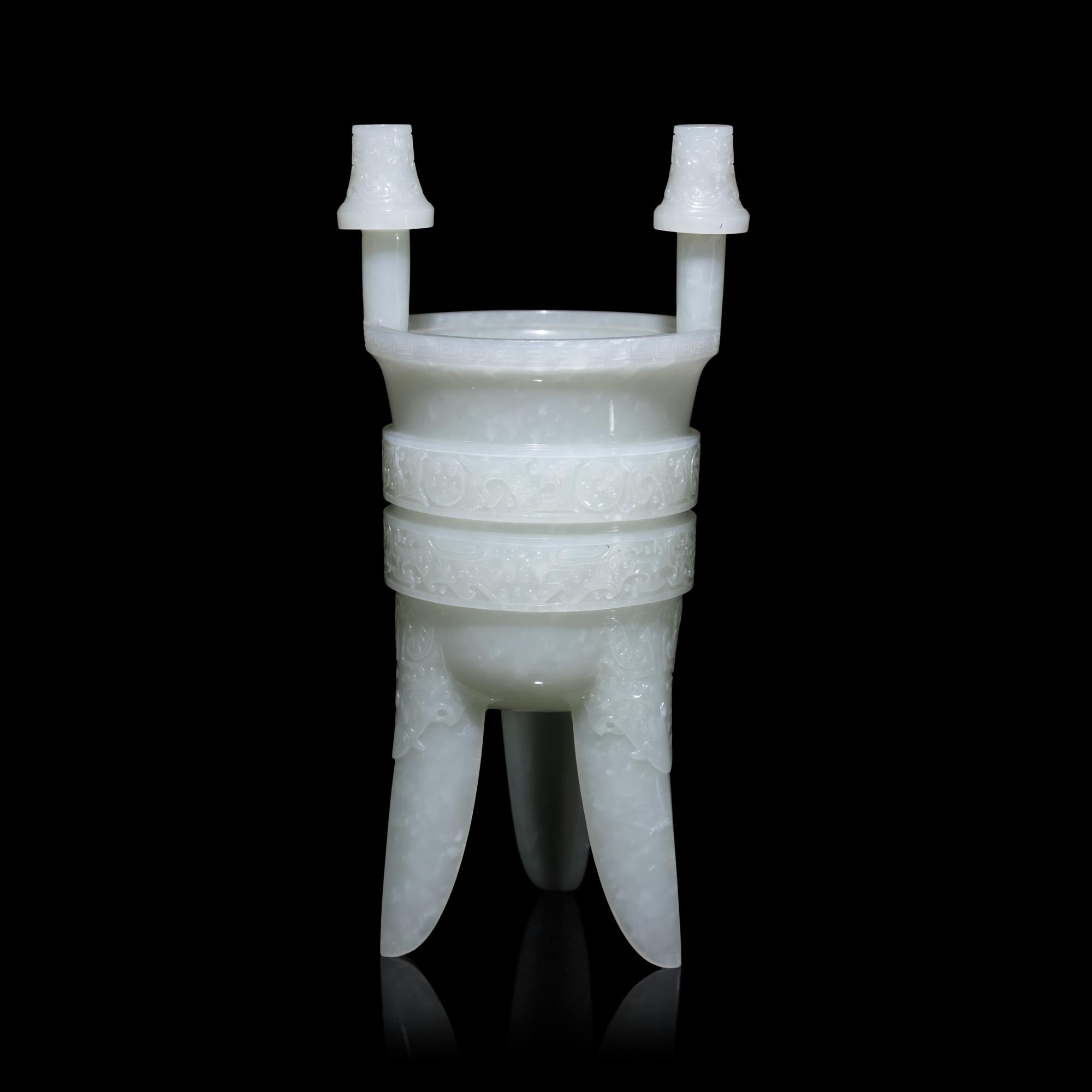 A Chinese Carved Pale Celadon Jade Tripod Vessel, Jia, Late Qing - Early Republic Period 晚清/民國 青白玉仿古斝