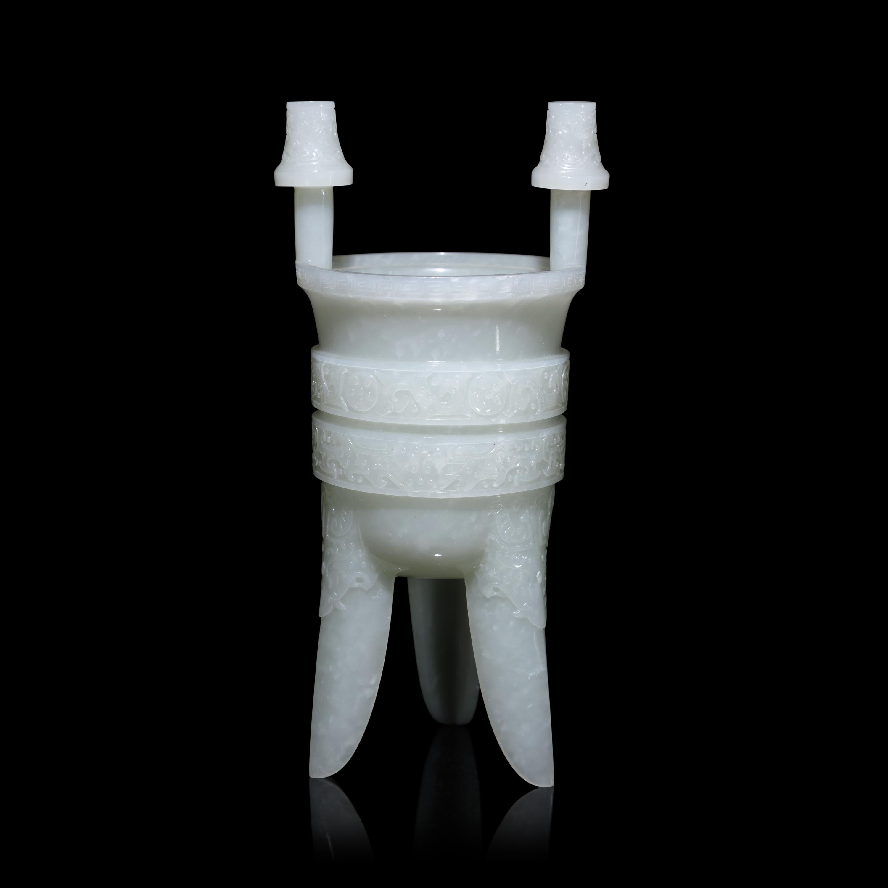 A Chinese Carved Pale Celadon Jade Tripod Vessel, Jia, Late Qing - Early Republic Period 晚清/民國 青白玉仿古斝
