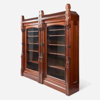 A glazed walnut double bookcase Attributed to Frank Furness (American, 1839-1912) and Daniel Pabst (American, b. Germany, 1826-1910), USA, circa 1875-1885