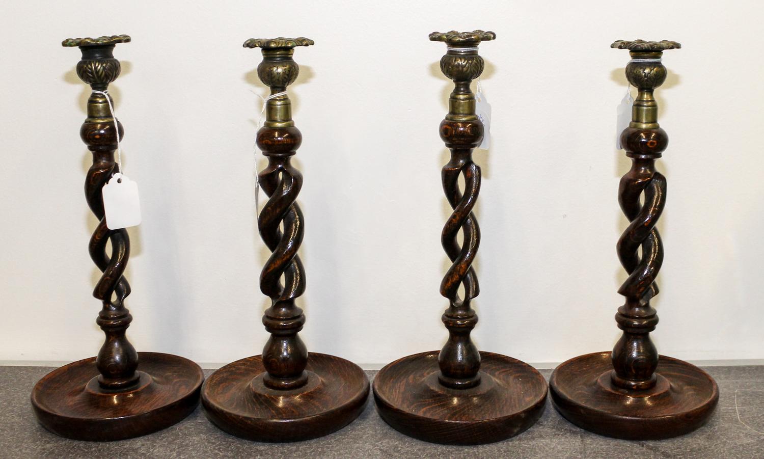 A Set of Four Twisted Wood Candlesticks. Height 12 1/2 inches.
