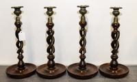 A Set of Four Twisted Wood Candlesticks. Height 12 1/2 inches.