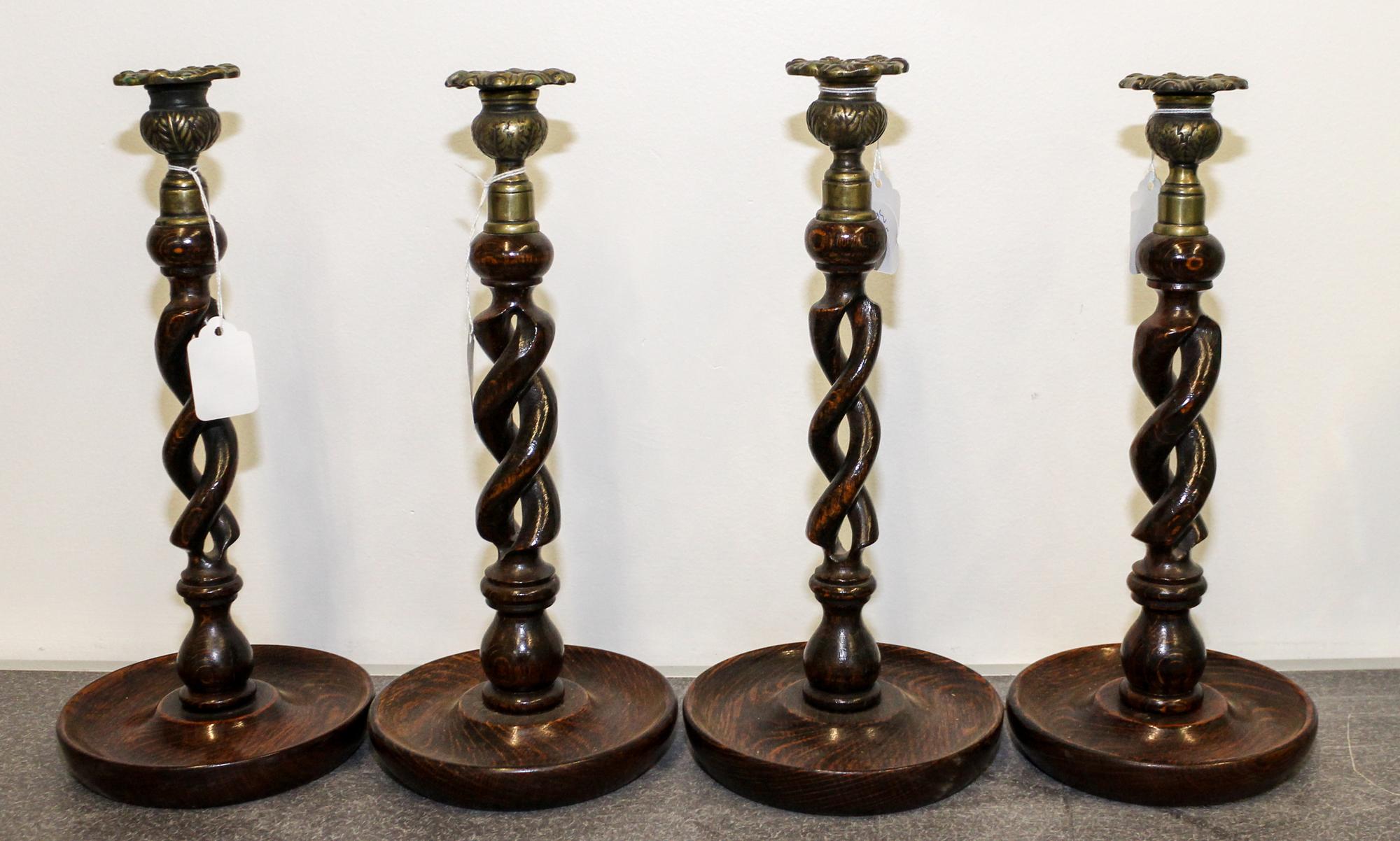 A Set of Four Twisted Wood Candlesticks. Height 12 1/2 inches.