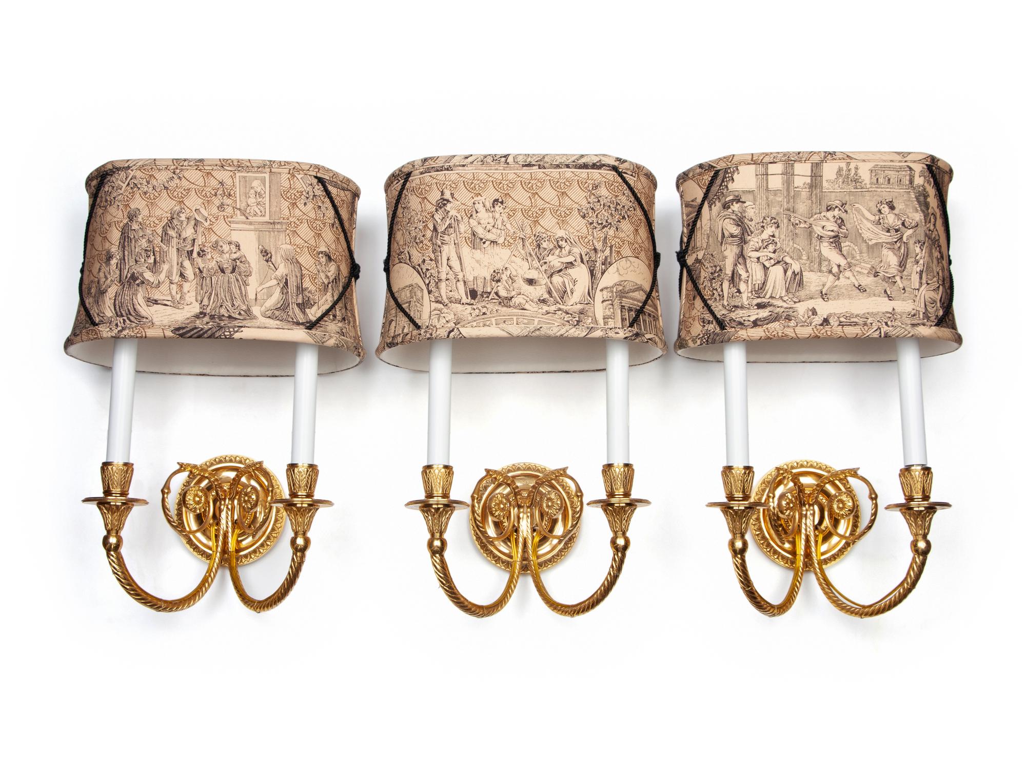 A Set of Three Gilt Metal Two-Light Sconces with Custom Shades