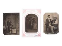 [EARLY PHOTOGRAPHY]. A group of 3 tintypes of photographers with their cameras or examples of their work.