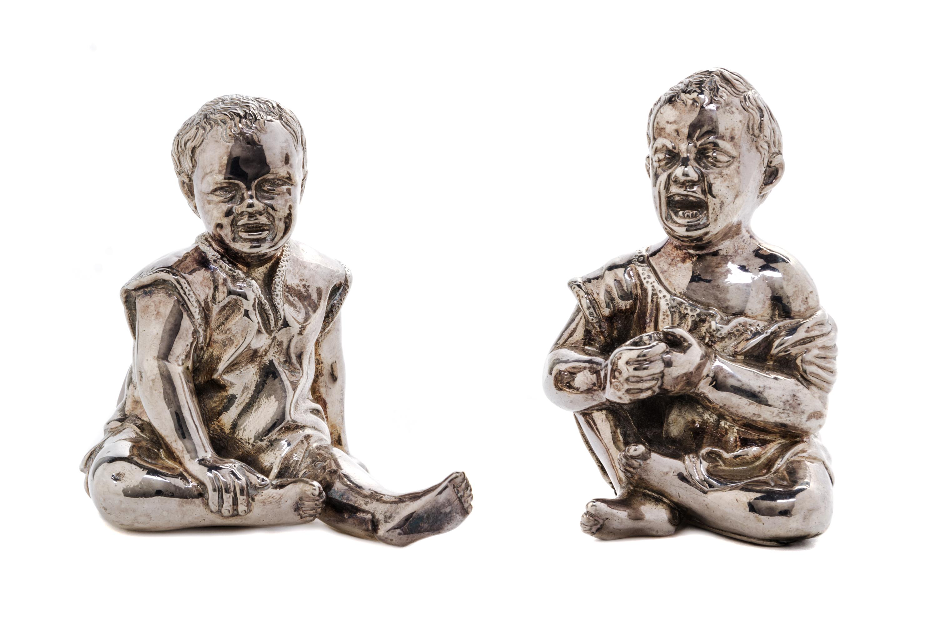 A Pair of Victorian Silver Figural Condiment Containers, Thomas Johnston II, London, 1886, each in the form of a seated child, one laug