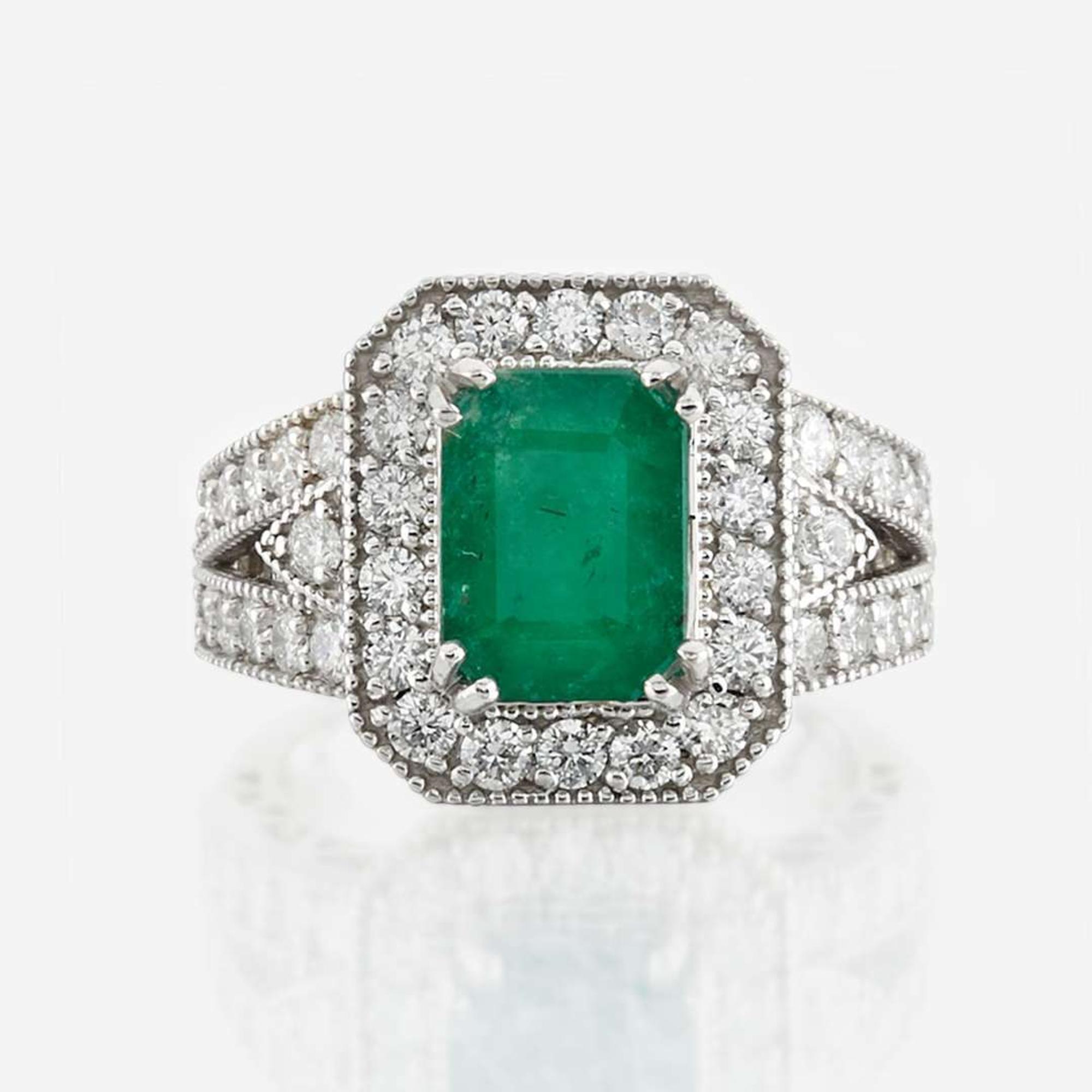 An emerald, diamond, and white gold ring