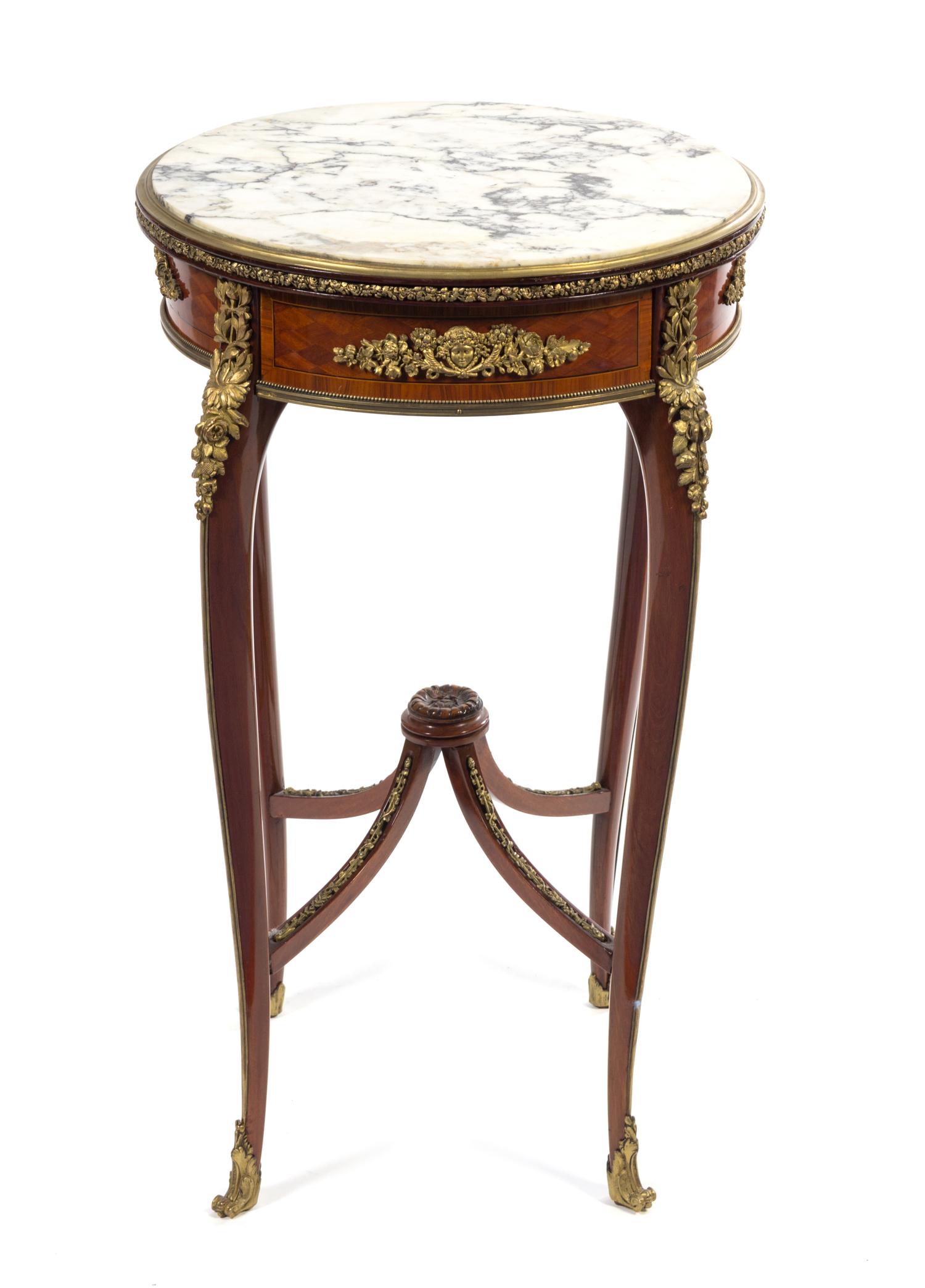 A Louis XV/XVI Transitional Style Gilt Bronze Mounted Parquetry Table Height 30 x diameter of top 18 inches. — FRANCOIS LINKE, PARIS, LATE 19TH CENTURY