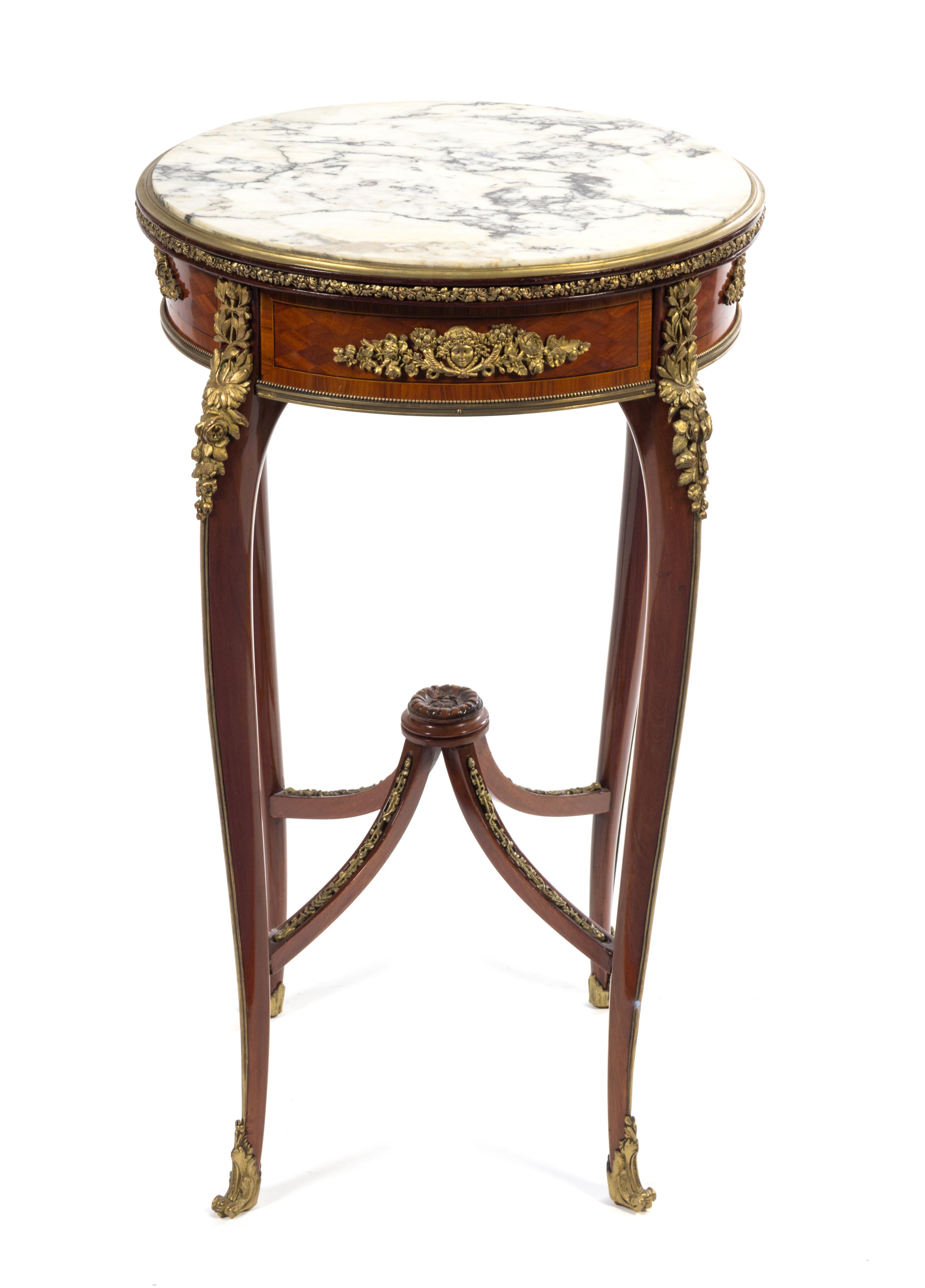 A Louis XV/XVI Transitional Style Gilt Bronze Mounted Parquetry Table Height 30 x diameter of top 18 inches. — FRANCOIS LINKE, PARIS, LATE 19TH CENTURY